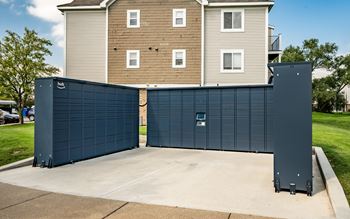 A large blue garage door in front of a two-story building.